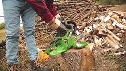 Lumberjack fixing / maintain the chainsaw outdoors. Stock Footage