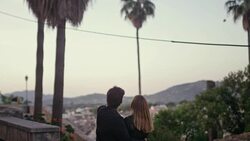 Happy couple on vacations. Old town panorama in background Stock Footage
