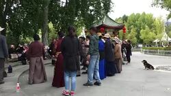 Lhasa people dance in Zong Jiao Lu Kang park under Potala Palace. Stock Footage