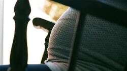 Pregnant Woman In Rocking Chair Holding Belly. Stock Footage
