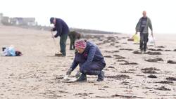 Volunteers and workers from Southern Water take part in a clean-up operation at Camber Sands  News Clip