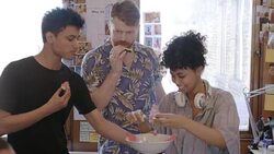 Creative business people talking and eating watermelon in open plan office Stock Footage