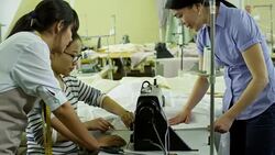 Seamstresses Using Sewing Machine at Work Stock Footage