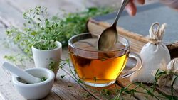 Herbal tea cup, bunch of shepherds purse, mortar of bursa pastoris medicinal herbs, old book. Stock Footage