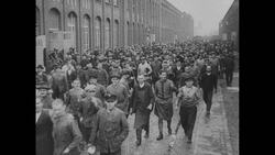 Workers Flock Past Factory (from Berlin 1920-1929) Stock Footage