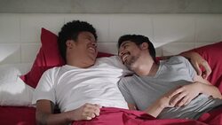 Young Gay Men Laughing And Relaxing In Bed At Home Stock Footage