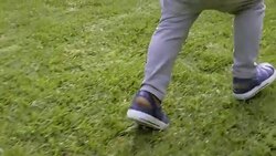 Little boy running on grass in slow motion Stock Footage