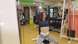 Young brunette works out with hand weights in gym. Stock Footage