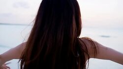 Ethnic Asian Chinese girl on ocean beach Bahamas Stock Footage