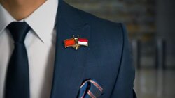 Businessman Walking Towards Camera With Friend Country Flags Pin China - Monaco Stock Footage