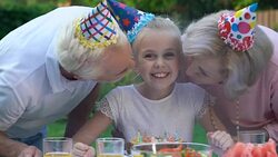 Cute birthday girl sincerely rejoicing relatives kiss on cheeks, congratulations Stock Footage