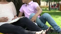 Son runs to pregnant mum to feel pushes of baby, second child anticipation Stock Footage