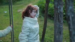 Little girl walks away from the swings Stock Footage