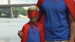 Kids entertainer and boy in superman costumes showing thumbs up, leisure center Stock Footage