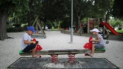 Kids playing on teeter totter Stock Footage