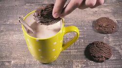 The boy dips cookies in cocoa Stock Footage