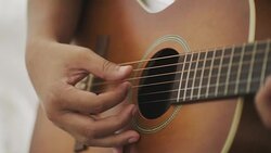 Guitarist is playing guitar while using capo Stock Footage