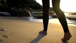 Close up of unrecognizable woman walking barefoot at the beach Stock Footage