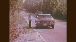 1970s: Kid walks down side of street, car pulls over to kid Stock Footage