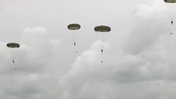 Crowds watching D-Day anniversary parachute drop News Clip