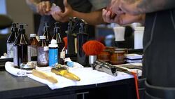 Barber examining various tools in hair salon Stock Footage