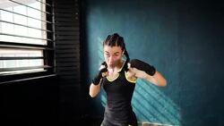 beautiful young moving boxing woman training punching in fitness studio Stock Footage