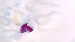 Radishes falling into milk in slow motion 250fps Stock Footage
