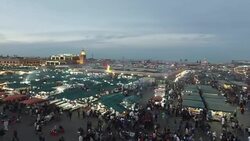 Evening Djemaa El Fna Square with Koutoubia Mosque, Marrakech, Morocco Stock Footage