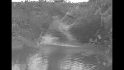 Korean soldiers crossing stream and shooting rifle and machine gun near Seoul during the Korean War in 1952 News Clip