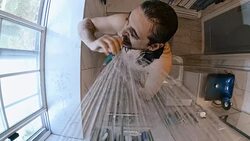 Mature 45-years-old man brushing teeth under the shower in the domestic bathroom. Stock Footage
