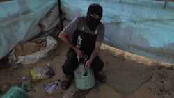 CLEAN : Masked Palestinians prepare incendiary balloons before setting it adrift News Clip