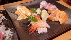 Pan shot of delicious plate of raw slice salmon and tuna sashimi in Japanese restaurant Stock Footage