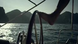 Woman steers the yacht with leg. Close-up Stock Footage