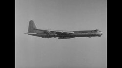 USAF bomber in flight over US carries and then releases USAF jet fighter which then returns to bomber News Clip