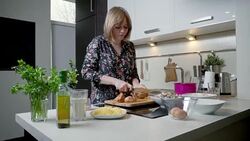 Young woman peeling and cutting onion Stock Footage