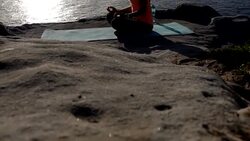Latin American woman enjoying ver vacation practicing yoga during sunrise next to the sea Stock Footage