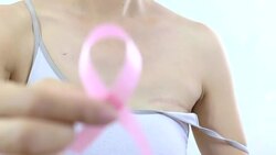 Woman making a pink ribbon Stock Footage