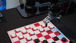 Robot plays checkers with a man in the gaming center Stock Footage