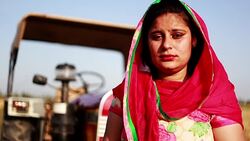 Indian women standing portrait near field & tractor Stock Footage