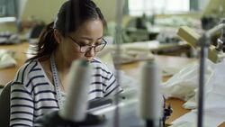 Concentrated Woman Using Sewing Machine Stock Footage