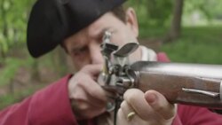 Cloud of smoke forming around Revolutionary War soldier aiming musket Stock Footage