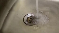 Close up of kitchen sink drain with water drop - Stock video... Stock Footage