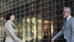 Business people greeting outside office building Stock Footage