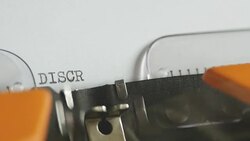 Close up shot of a person writing DISCRIMINATION on an old typewriter, with sound Stock Footage