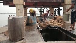 Fishermen washing oil-polluted fishing nets in Venezuela News Clip