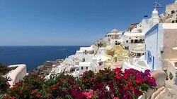 Scenic overlook of Oia Santorini Greece with flowers Stock Footage