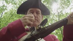 Revolutionary War reenactor loading musket Stock Footage