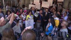 Protesters carry cages with dolls inside Instructional Video