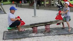 Kids playing on teeter totter Stock Footage