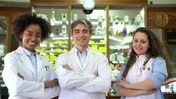 Smiling chemists with arms crossed at pharmacy Stock Footage